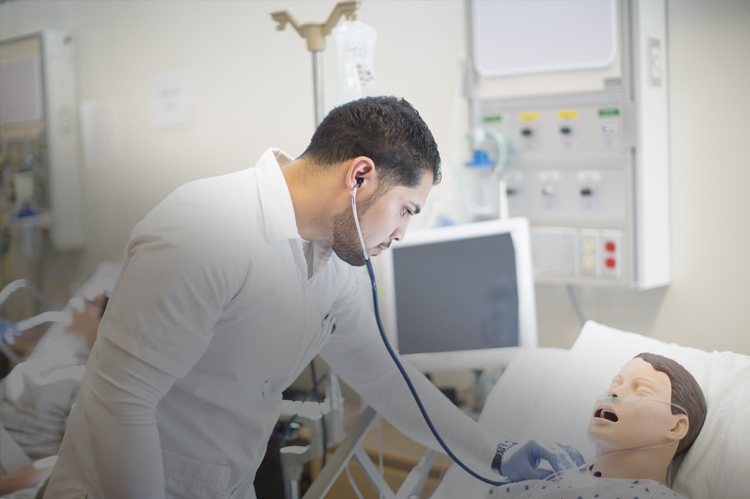 Nurse practicing with mannequin patient.