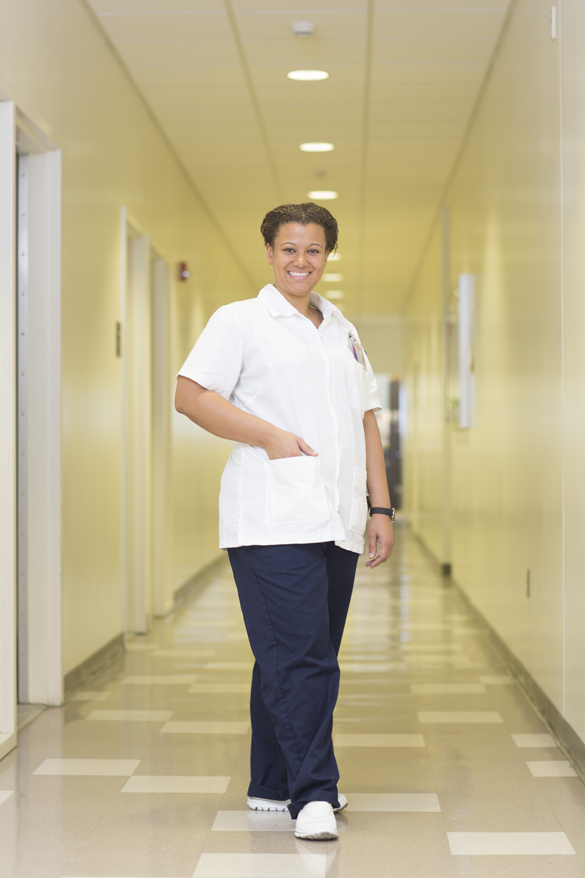 Nursing student standing in hallway.