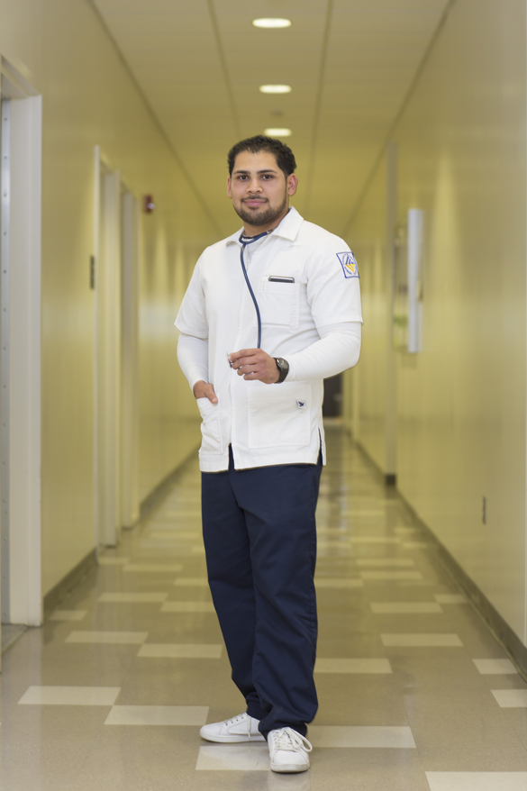 Nursing student standing in hallway.