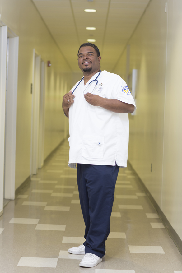 Nursing student standing in hallway.