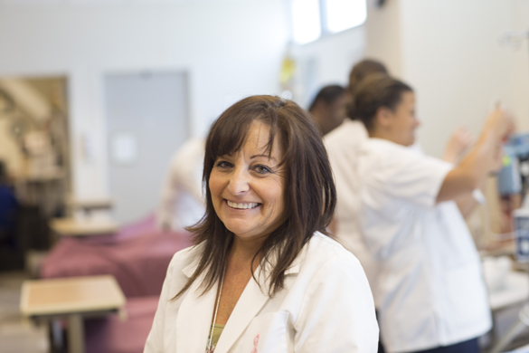 Nursing instructor in lab with students.