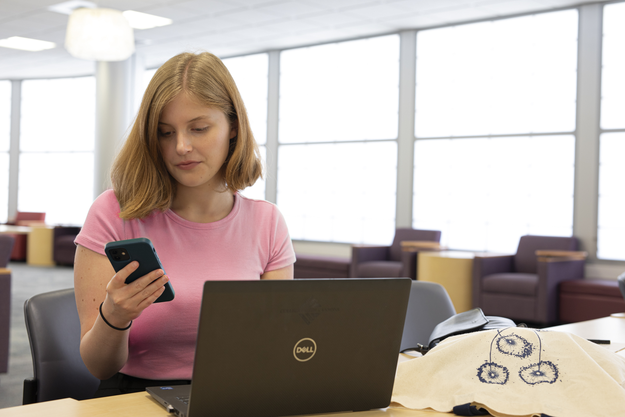 Student with mobile and laptop