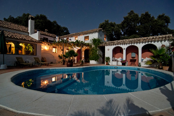 Two-story Tuscan home with balcony, pool, landscaping.