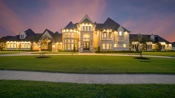 Exterior of wealthy modern home at evening.