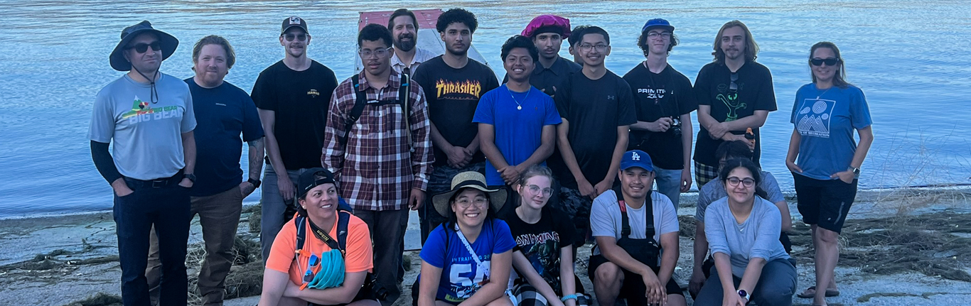 Students at the lake water's edge.