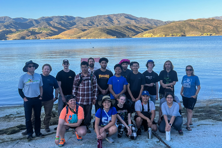 Students at the lake water's edge.