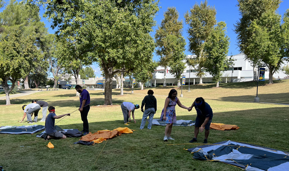 Students setting up tents on lawn at College of the Canyons.