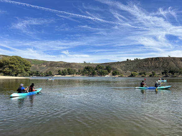 Students kayaking on a lake.