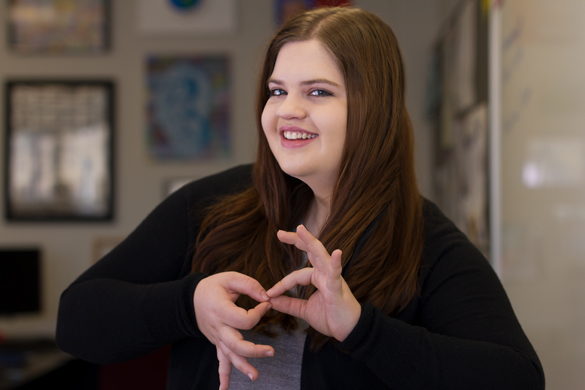 Student using sign language. 