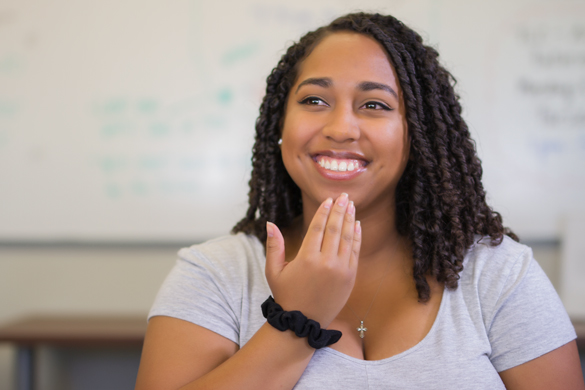 Student using sign language. 