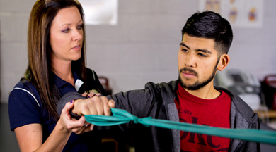 Sports Medicine faculty working with athelete.