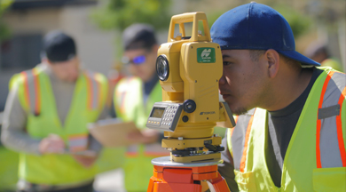 Student surveyor looking through surveying equipment.  photo © Robin Spurs