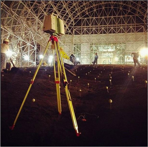 Surveyors working indoors at night.