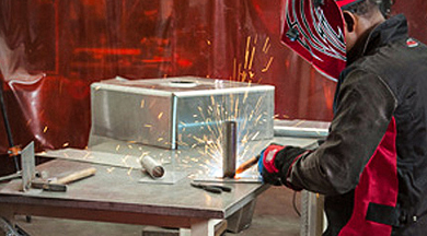 Young man welding.