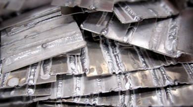 Scraps of metal with practice welds. photo © Robin Spurs