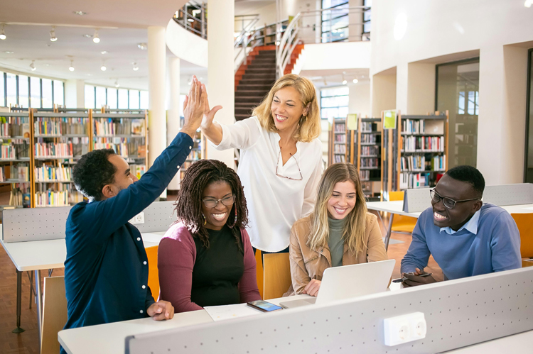 Group of ethnically varied students in a library.