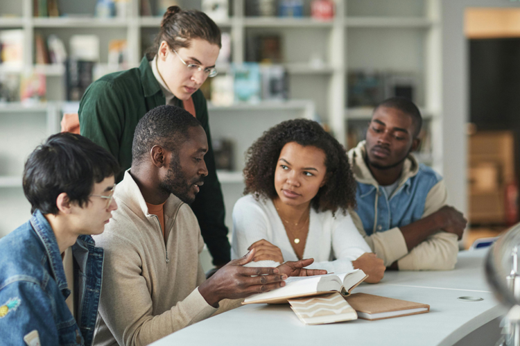 Group of ethnically varied students in a classroom.