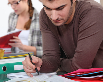 Student Writing on Notebook