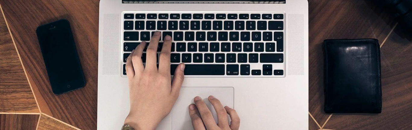  Student hands on laptop keyboard.