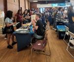 Students at check-in table at CougarFest