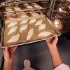 GoPro point of view: Student loading Pointy French Bread into oven.